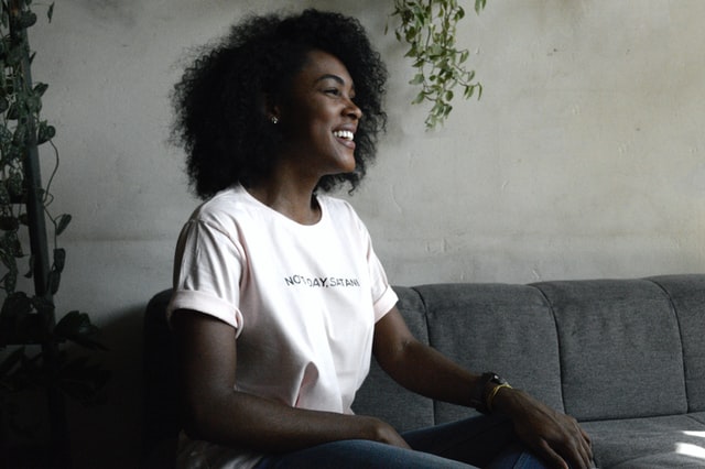 Woman smiling sitting on couch